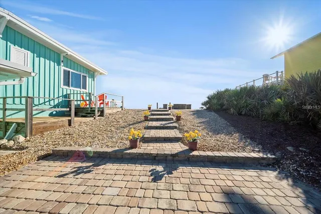 a view of a patio with table and chairs and potted plants