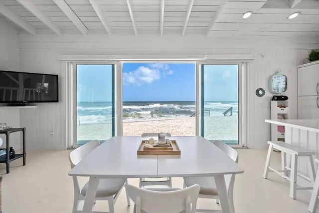 a view of a dining room with furniture and a window
