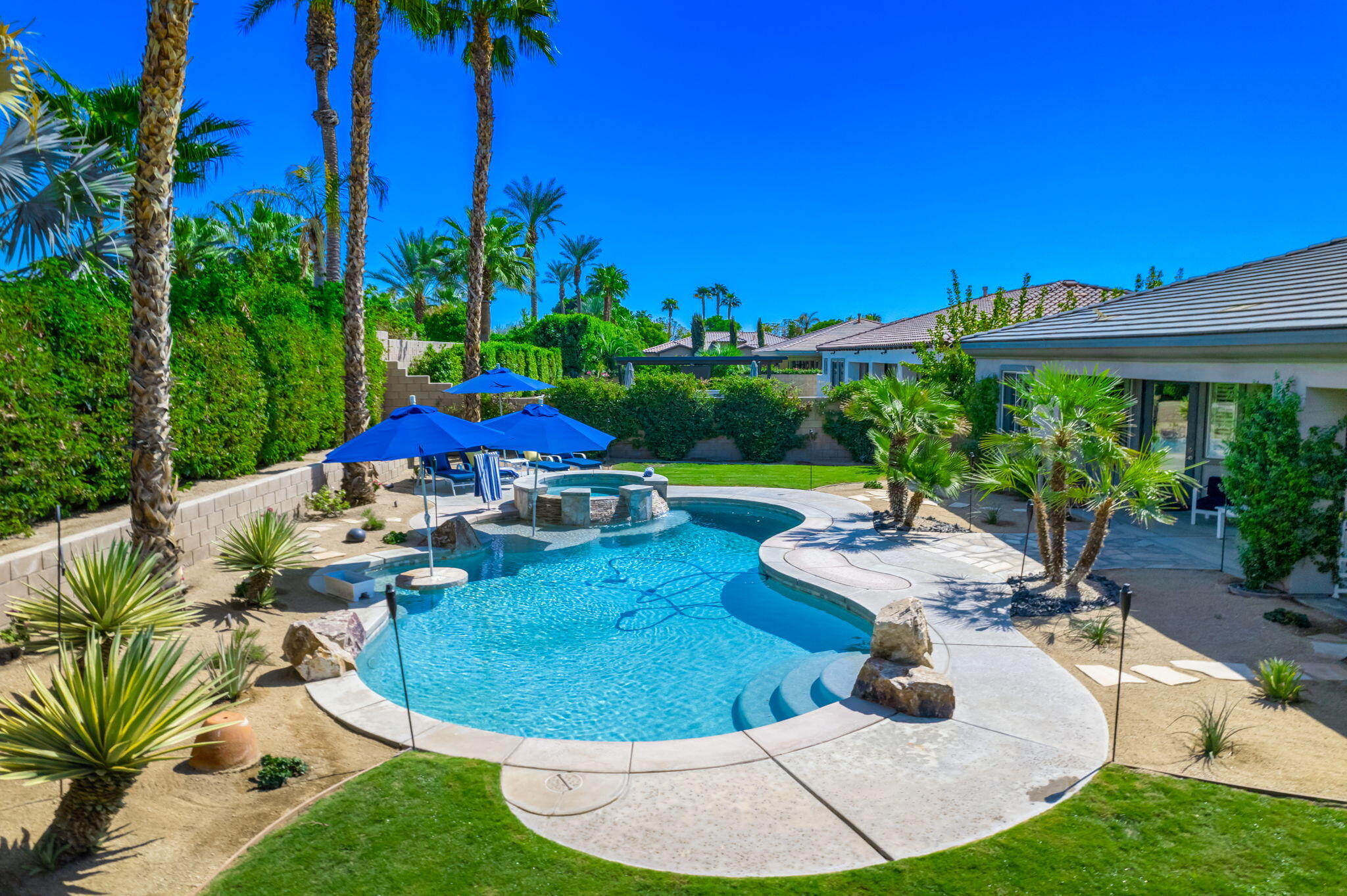 80676 Plum Lane Indio, CA 92201 - Photo 7 of 26 a view of a backyard with plants and patio