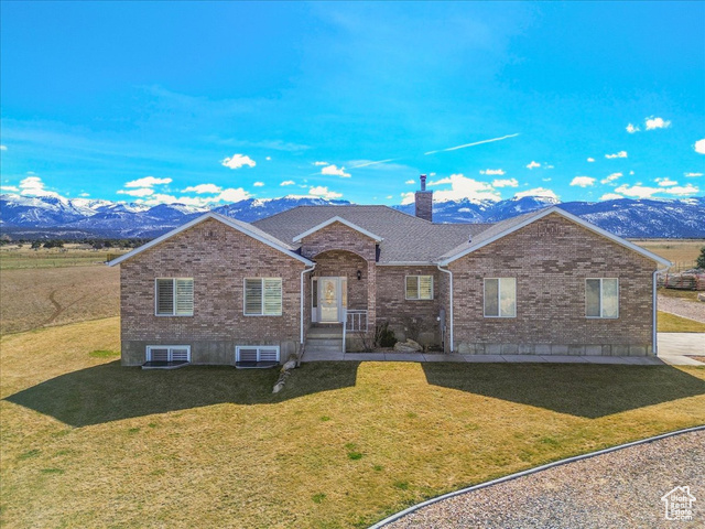 14480 North 8375th Spring East Spring City, UT 84662 - Photo 1 of 1 Single story home featuring a front lawn, brick siding, a chimney, and a mountain view