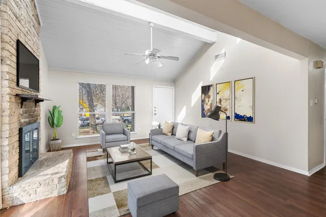 a living room with fireplace furniture and a wooden floor