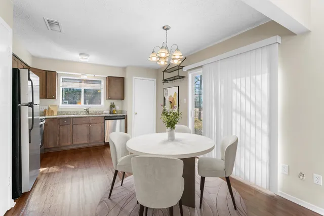 a view of a dining room with furniture window and wooden floor