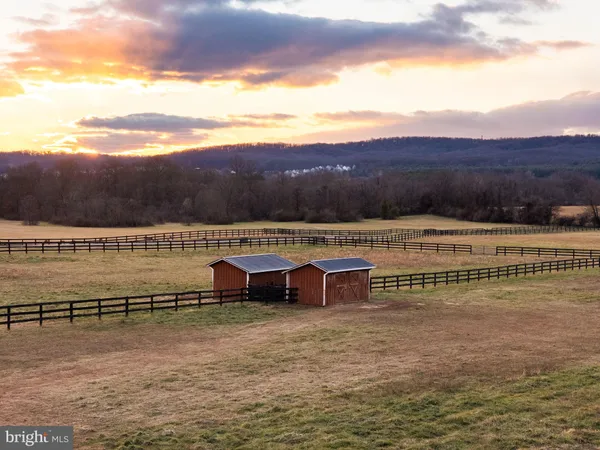 a living room with furniture and stairs