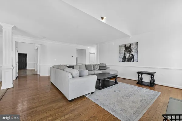 a view of hallway with wooden floor and stairs
