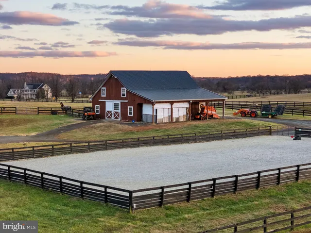 a front view of a house with a yard covered in snow