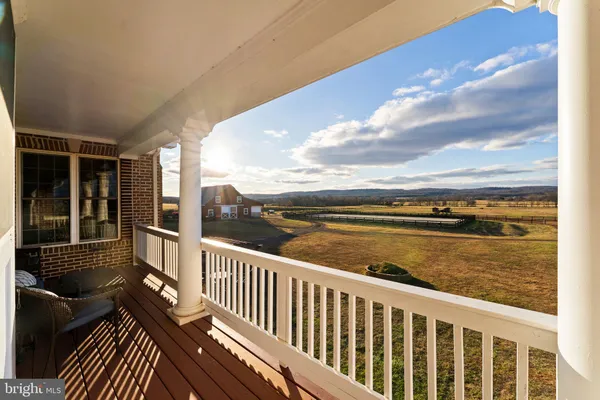 a front view of a house with a yard covered in snow
