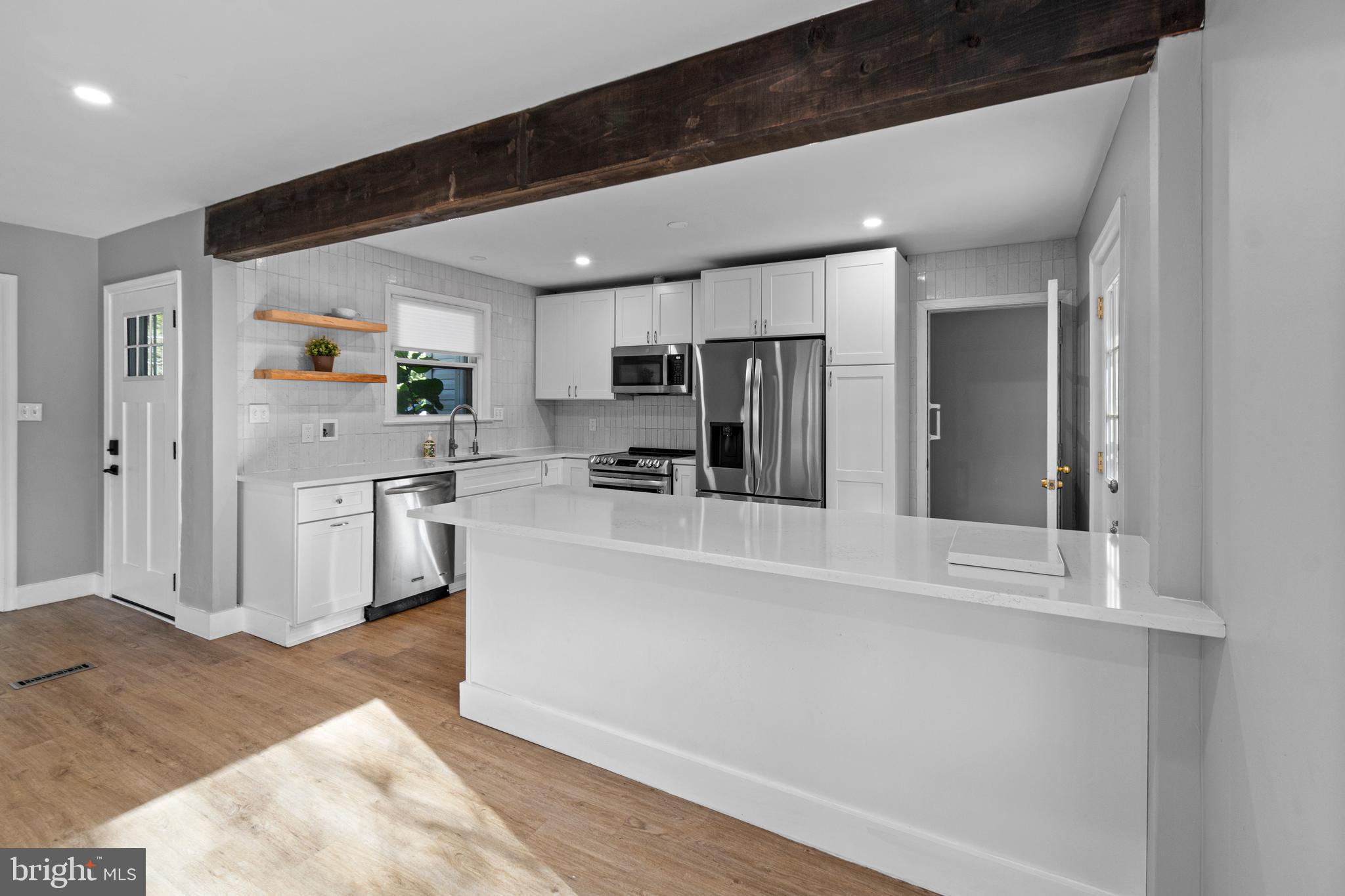9 Robinson Road Severna Park, MD 21146 - Photo 12 of 51 a kitchen with white cabinets and stainless steel appliances