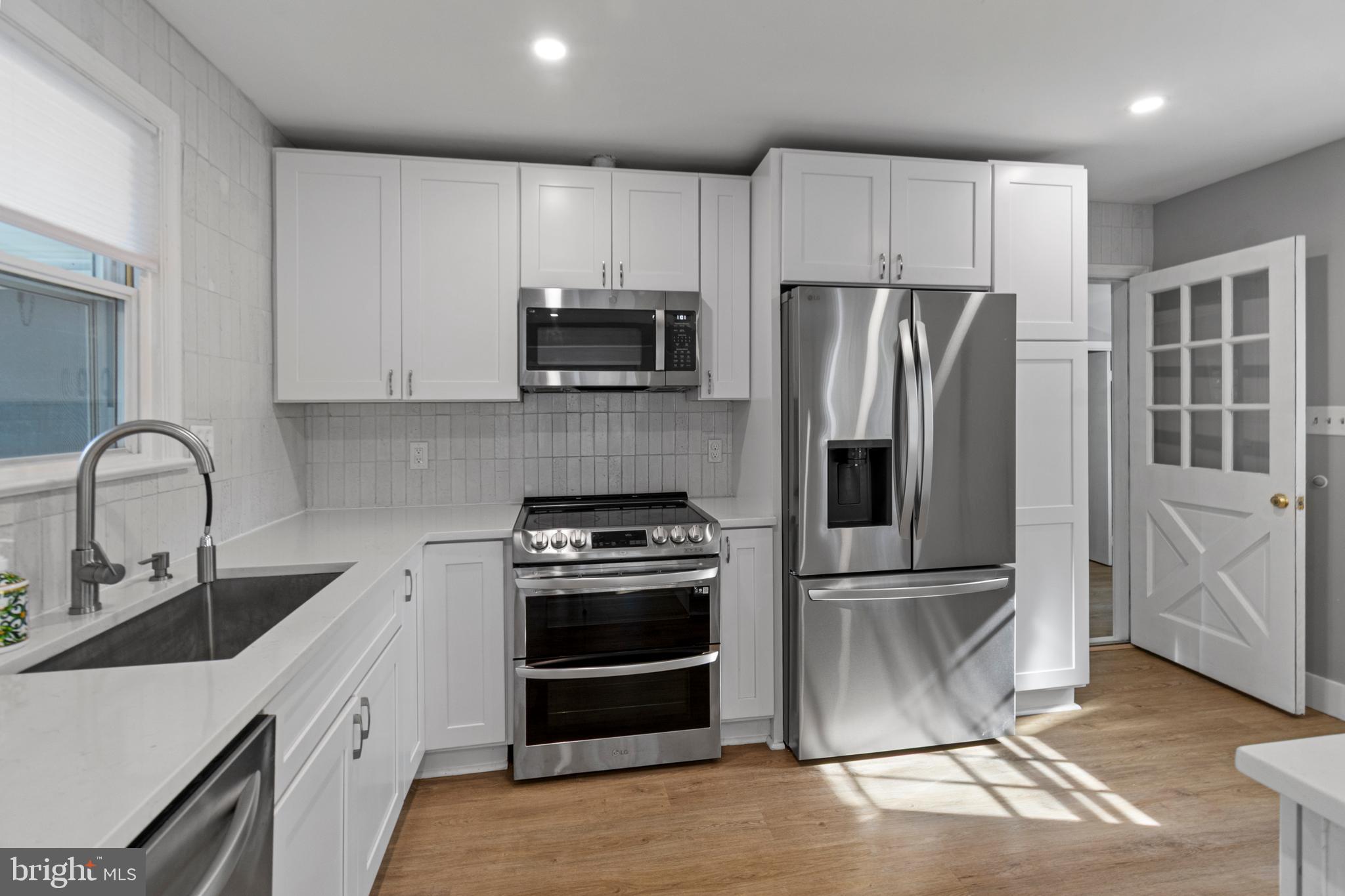 9 Robinson Road Severna Park, MD 21146 - Photo 14 of 51 a kitchen with appliances a sink and cabinets