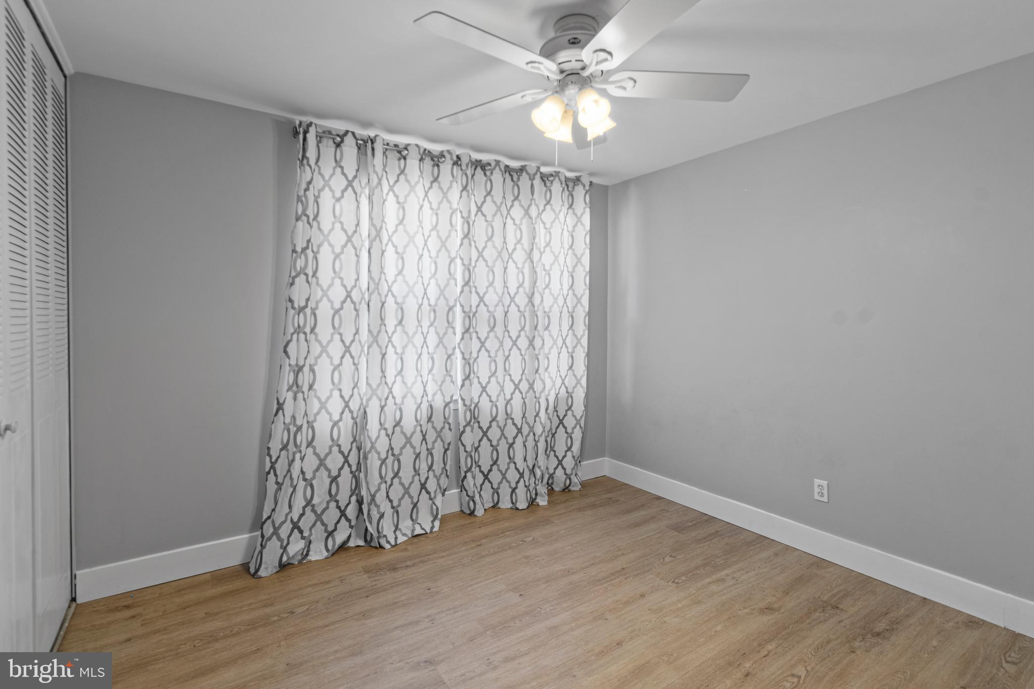 9 Robinson Road Severna Park, MD 21146 - Photo 22 of 51 an empty room with wooden floor fan and windows
