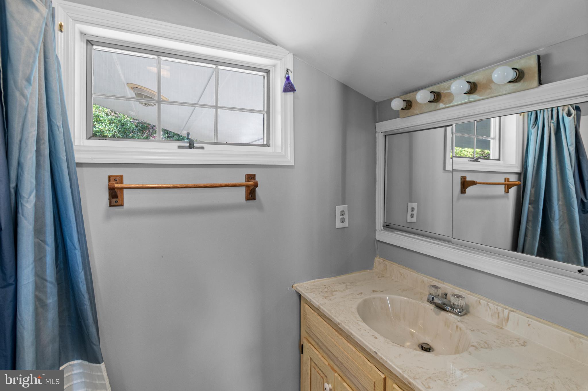 9 Robinson Road Severna Park, MD 21146 - Photo 34 of 51 a bathroom with a sink a vanity and a window