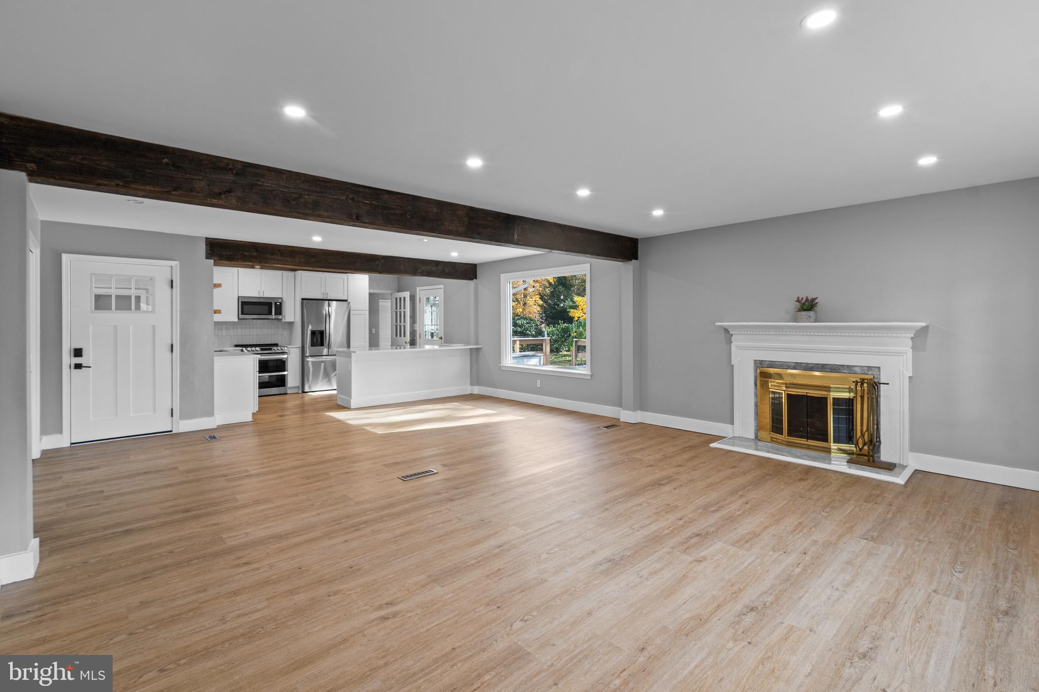 9 Robinson Road Severna Park, MD 21146 - Photo 5 of 51 an empty room with wooden floor and fireplace