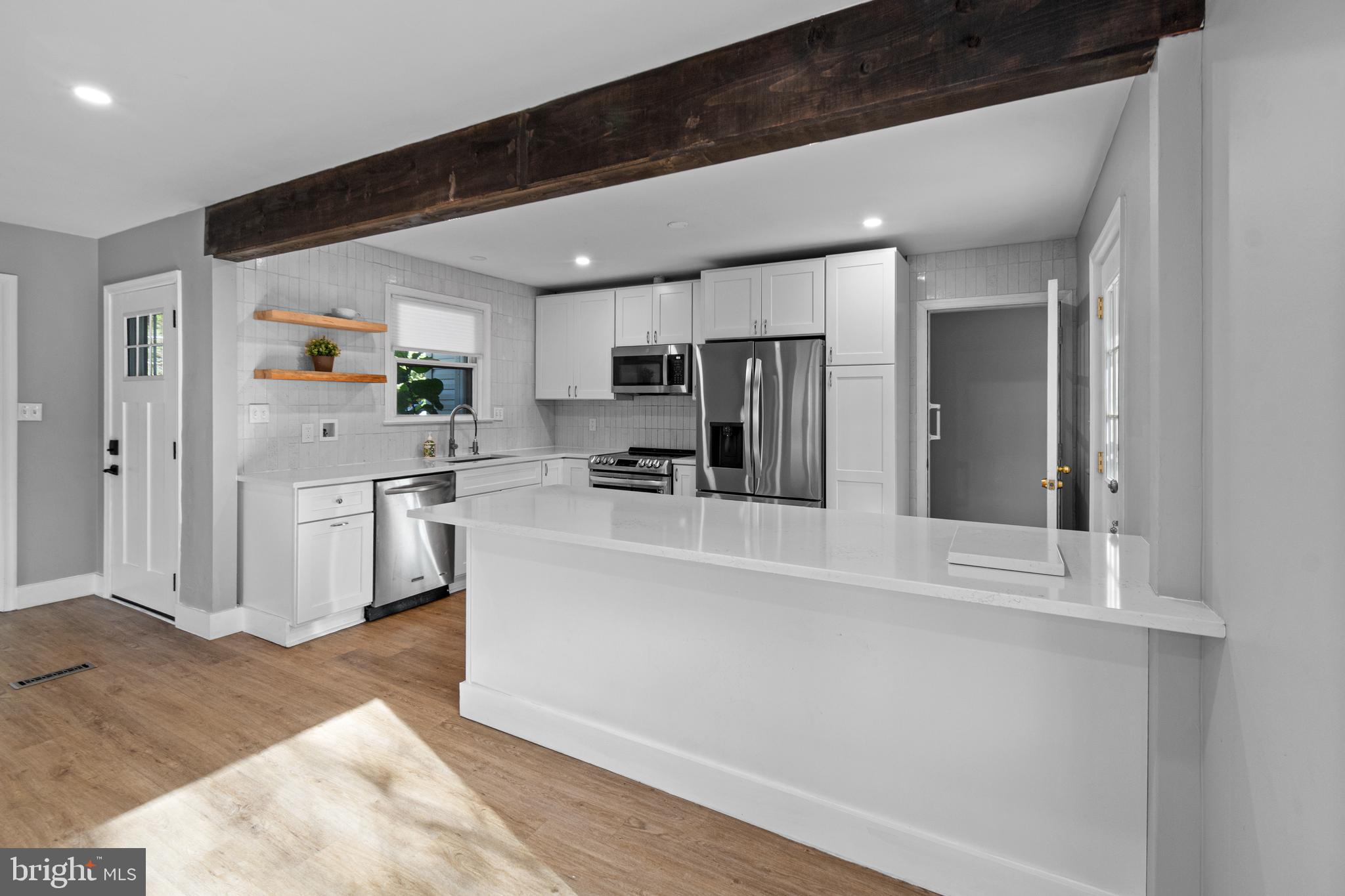 9 Robinson Road Severna Park, MD 21146 - Photo 7 of 51 a kitchen with white cabinets and stainless steel appliances