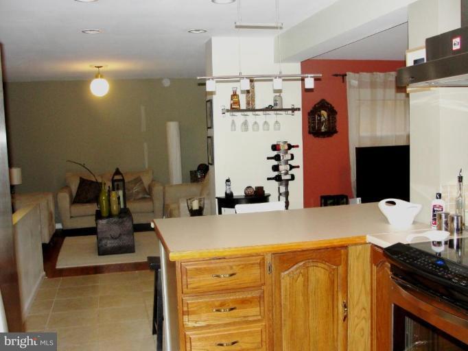 511 Waterford Road Silver Spring, MD 20901 - Photo 2 of 20 a kitchen with a refrigerator and a stove top oven