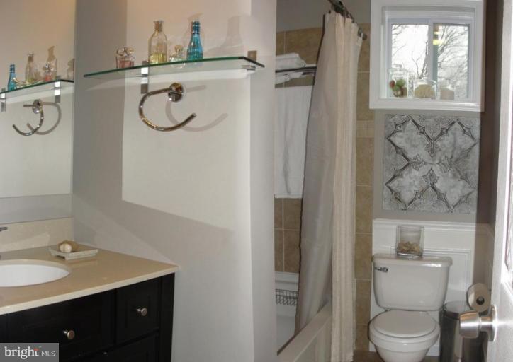 511 Waterford Road Silver Spring, MD 20901 - Photo 8 of 20 a bathroom with a toilet sink shower and mirror
