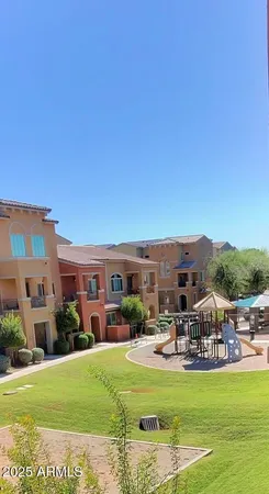 a view of a swimming pool and a table and chairs under an umbrella