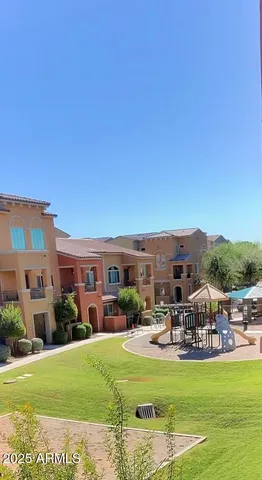a view of a swimming pool and a table and chairs under an umbrella