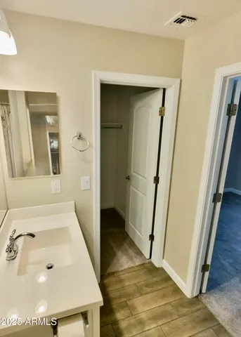 a large kitchen with stainless steel appliances a large counter top a stove and a refrigerator