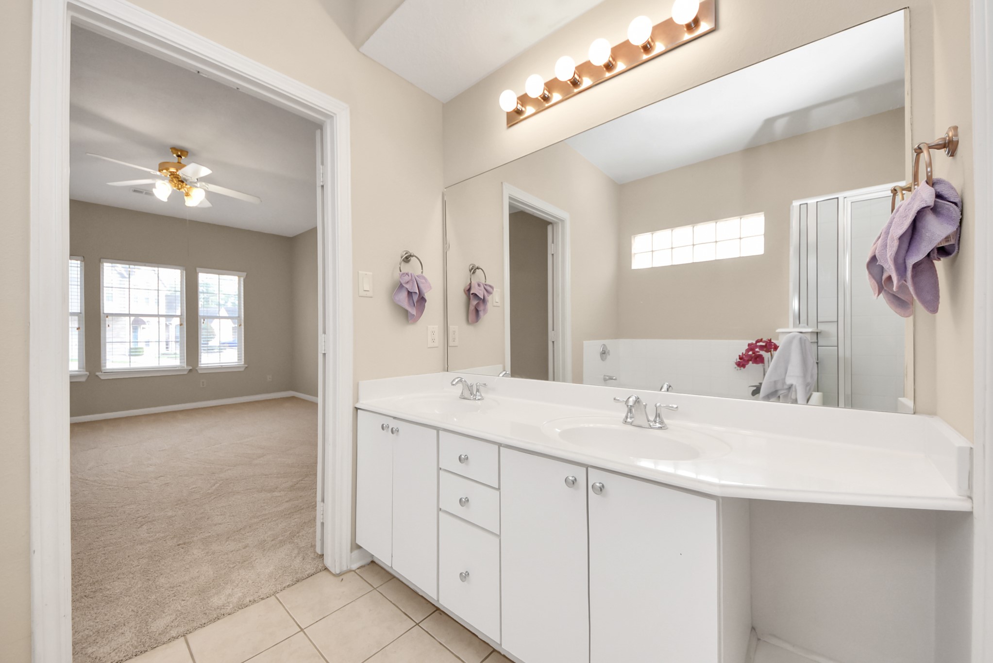 18963 Candlelight Crescent Road Spring, TX 77388 - Photo 19 of 33 Bathroom featuring double sinks and comfortable space for efficiency and for shared use.