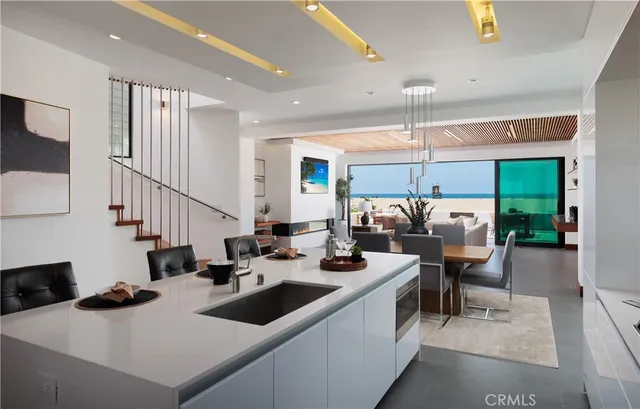 a kitchen with sink refrigerator and large window