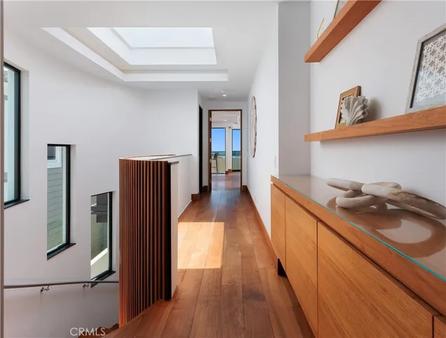 a hallway with cabinets and wooden floor