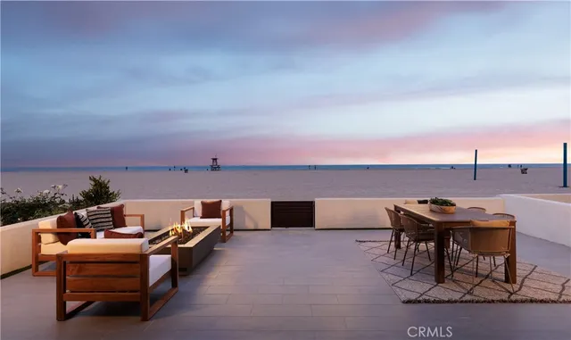 a terrace with outdoor seating and ocean view