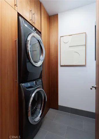 a bedroom with a bed lamp and wooden floor