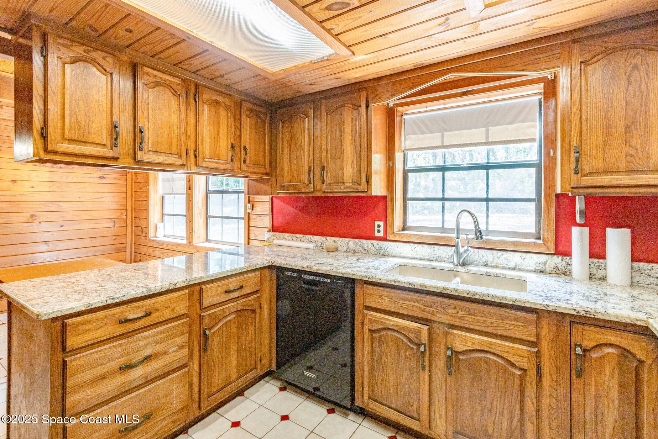 630 Chase Hammock Road Merritt Island, FL 32953 - Photo 11 of 37 a kitchen with stainless steel appliances granite countertop a sink and a cabinets