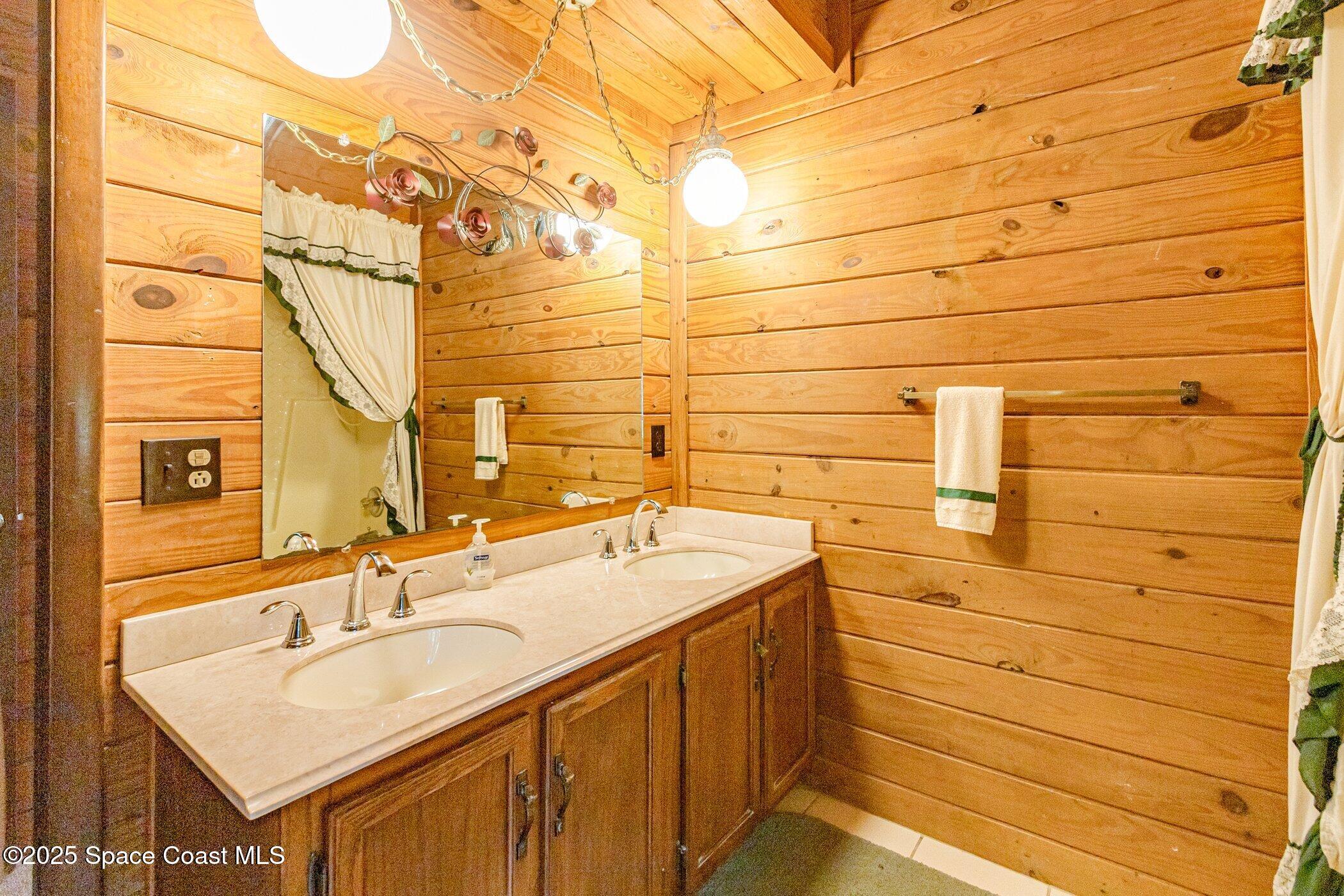 630 Chase Hammock Road Merritt Island, FL 32953 - Photo 19 of 37 a bathroom with a sink and a mirror