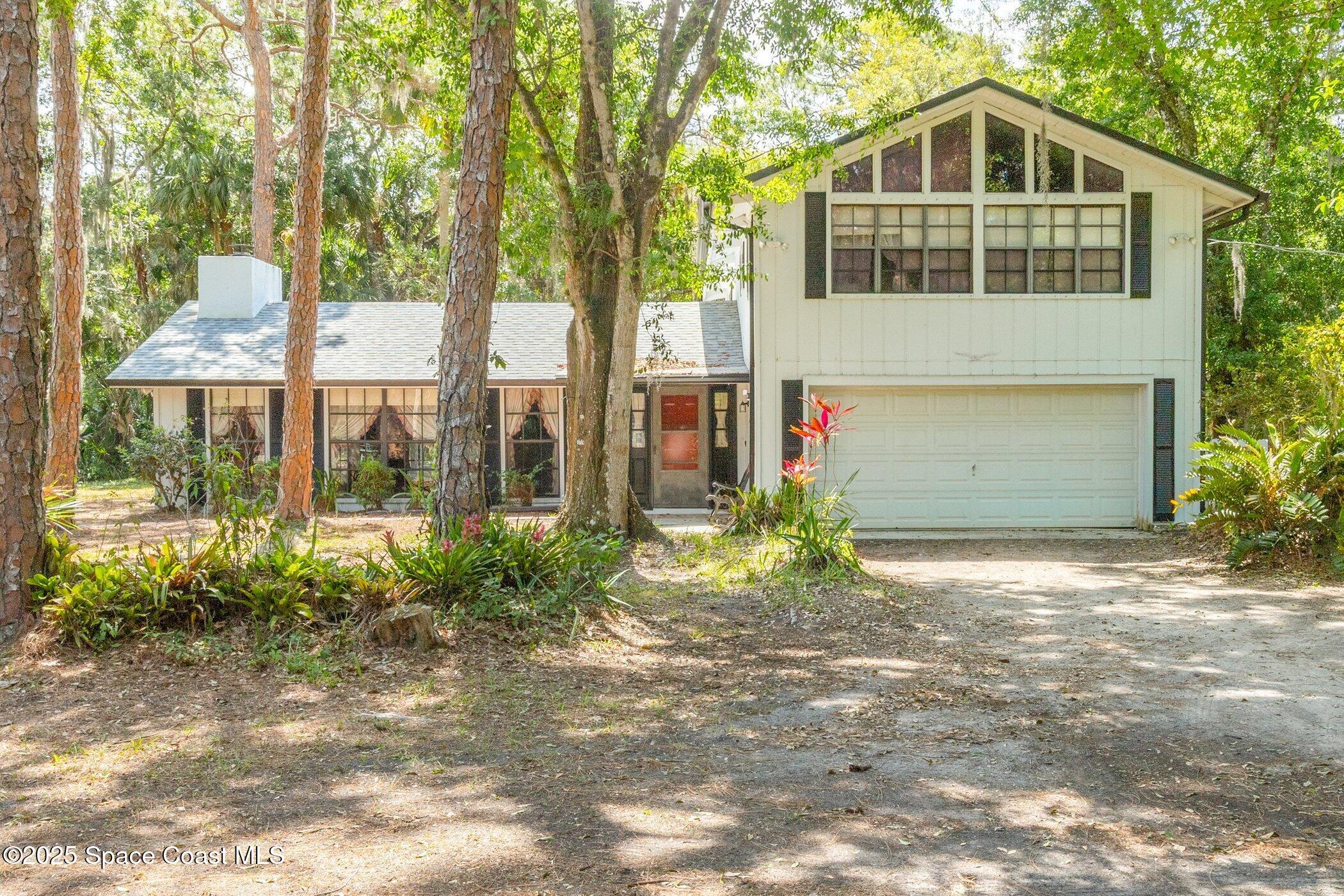 630 Chase Hammock Road Merritt Island, FL 32953 - Photo 2 of 37 a front view of a house with garden