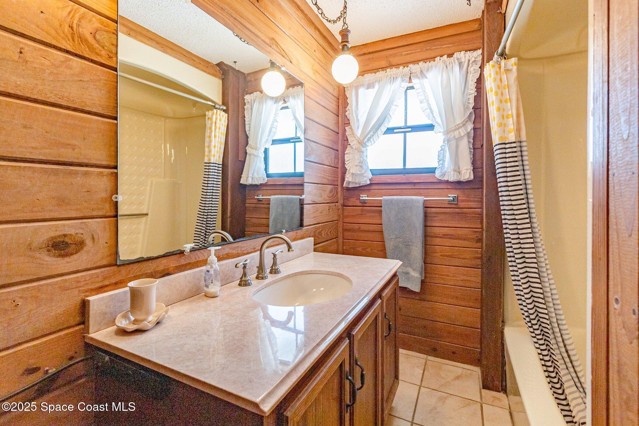 630 Chase Hammock Road Merritt Island, FL 32953 - Photo 24 of 37 a bathroom with a sink and a mirror