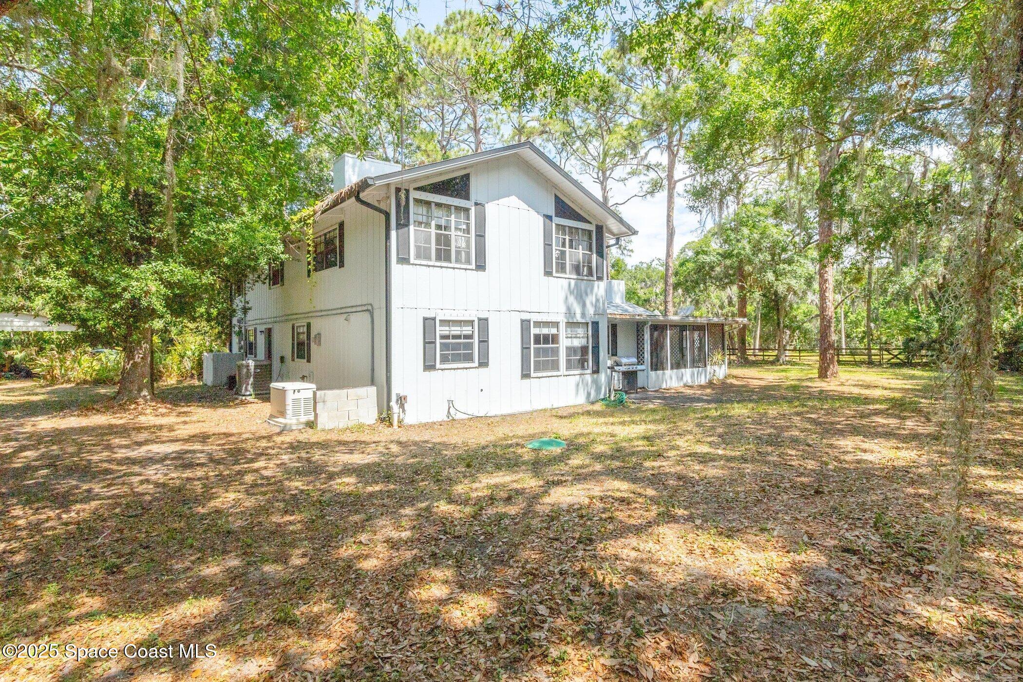 630 Chase Hammock Road Merritt Island, FL 32953 - Photo 26 of 37 a view of a house with a yard