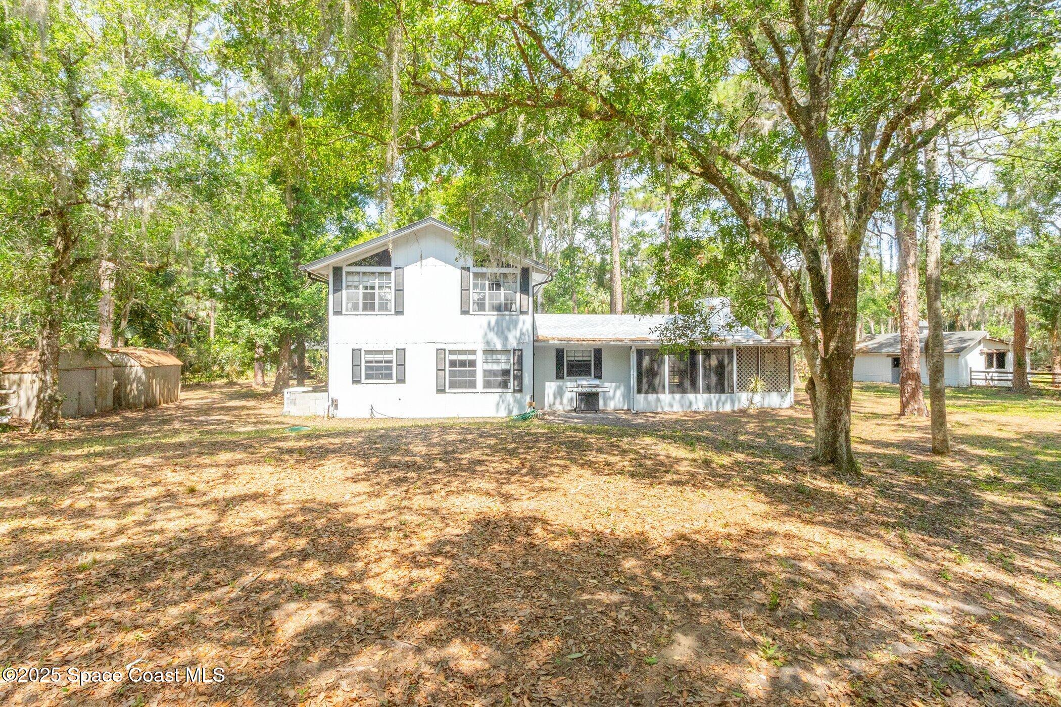 630 Chase Hammock Road Merritt Island, FL 32953 - Photo 27 of 37 a front view of a house with a garden