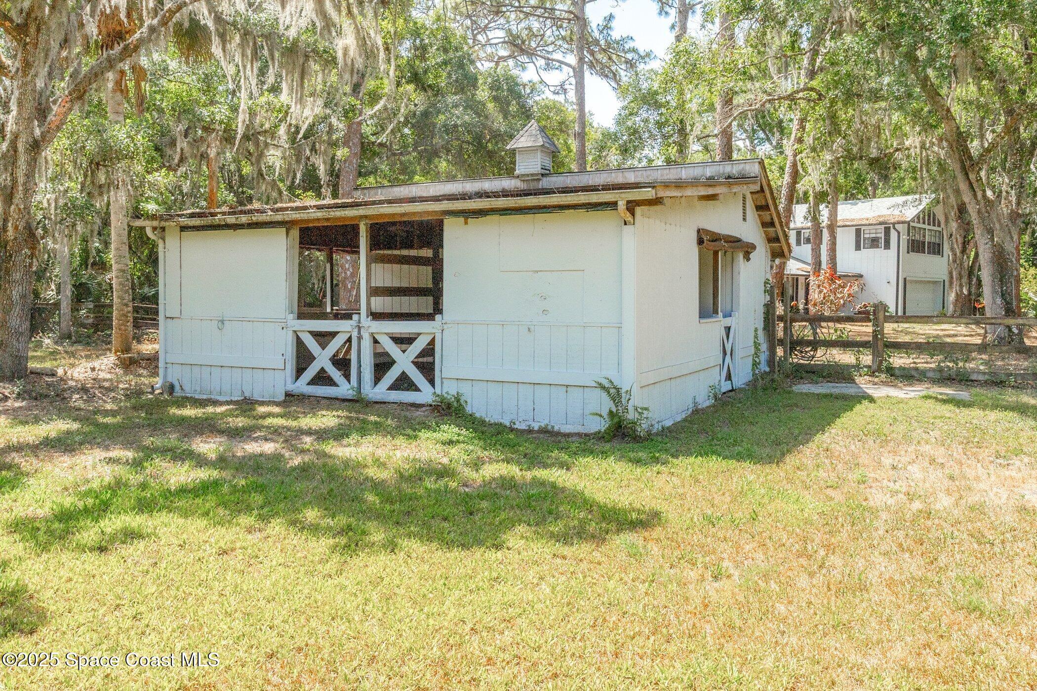 630 Chase Hammock Road Merritt Island, FL 32953 - Photo 28 of 37 a view of a backyard with a large tree