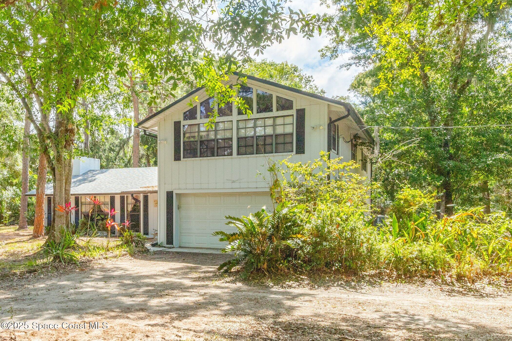 630 Chase Hammock Road Merritt Island, FL 32953 - Photo 32 of 37 a front view of a house with garden