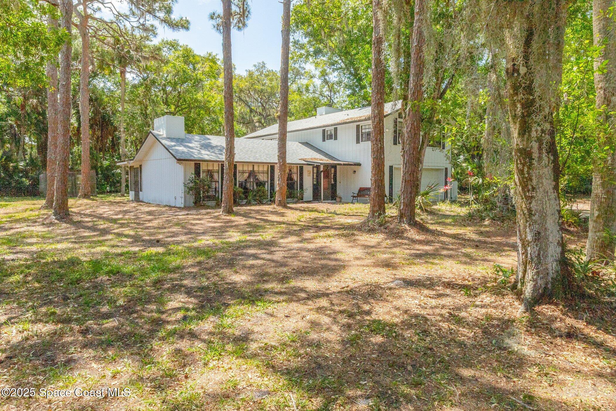 630 Chase Hammock Road Merritt Island, FL 32953 - Photo 33 of 37 a view of a house with backyard and tree