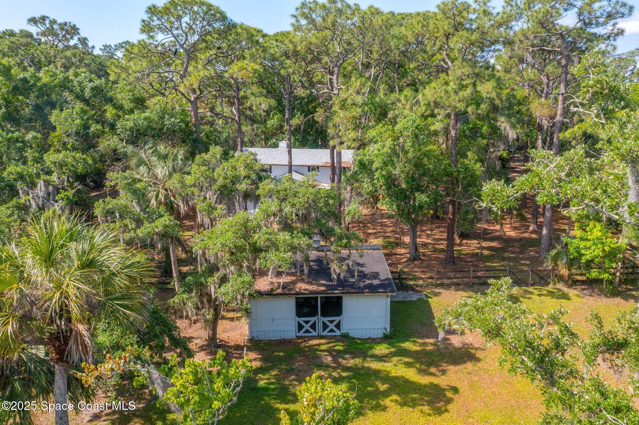 630 Chase Hammock Road Merritt Island, FL 32953 - Photo 35 of 37 a swimming pool with trees in the background