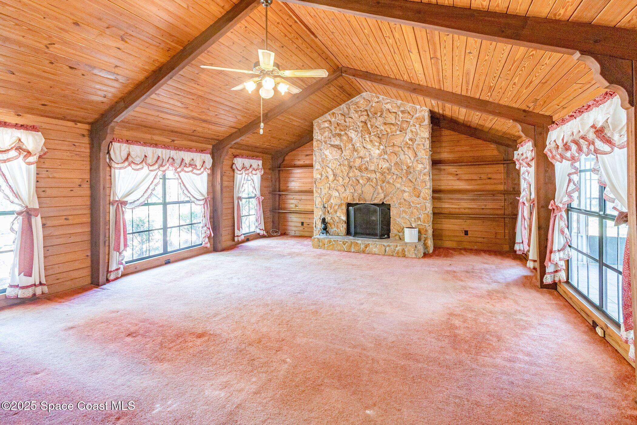 630 Chase Hammock Road Merritt Island, FL 32953 - Photo 6 of 37 a view of an empty room with a fireplace and a window
