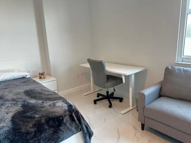 a bedroom with a bed and a chair