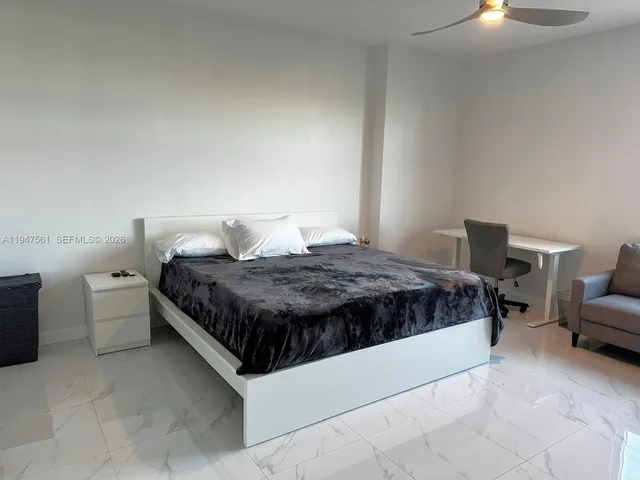 a bedroom with a bed and lamp