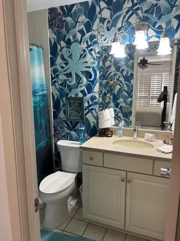 a bathroom with a sink and mirror with toilet