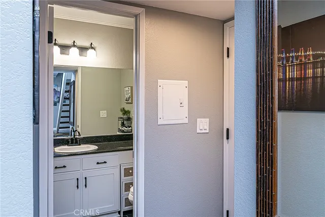 a bathroom with a granite countertop sink and a mirror