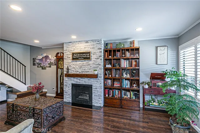 a living room with furniture a bookshelf and a fireplace