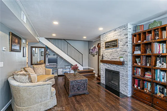 a living room with furniture and a book shelf