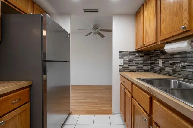a kitchen with a refrigerator and cabinets
