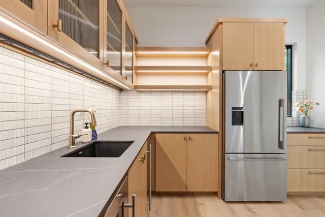 a kitchen with a refrigerator and a sink