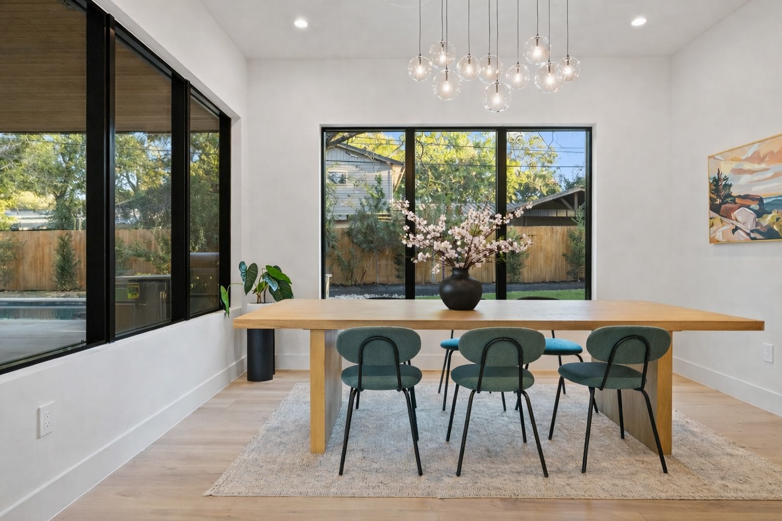 607 Westbrook Drive Austin, TX 78746 - Photo 26 of 32 a dining room with furniture a chandelier and wooden floor
