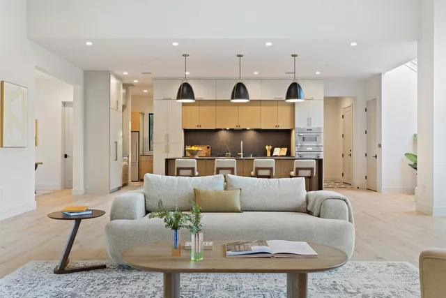 a living room with furniture a couch and a chandelier