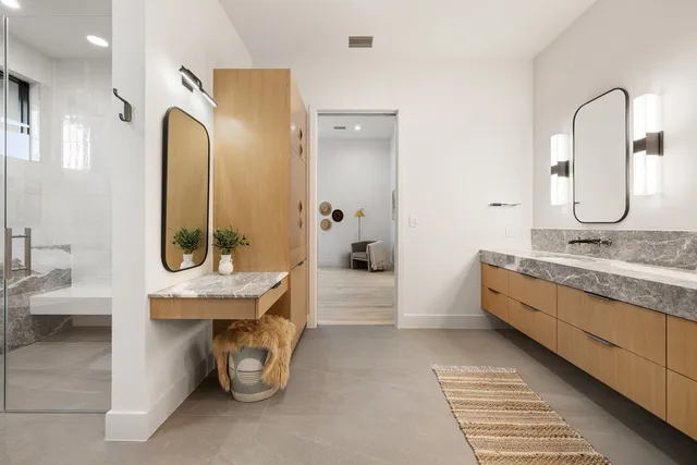 a bathroom with a granite countertop sink and a mirror