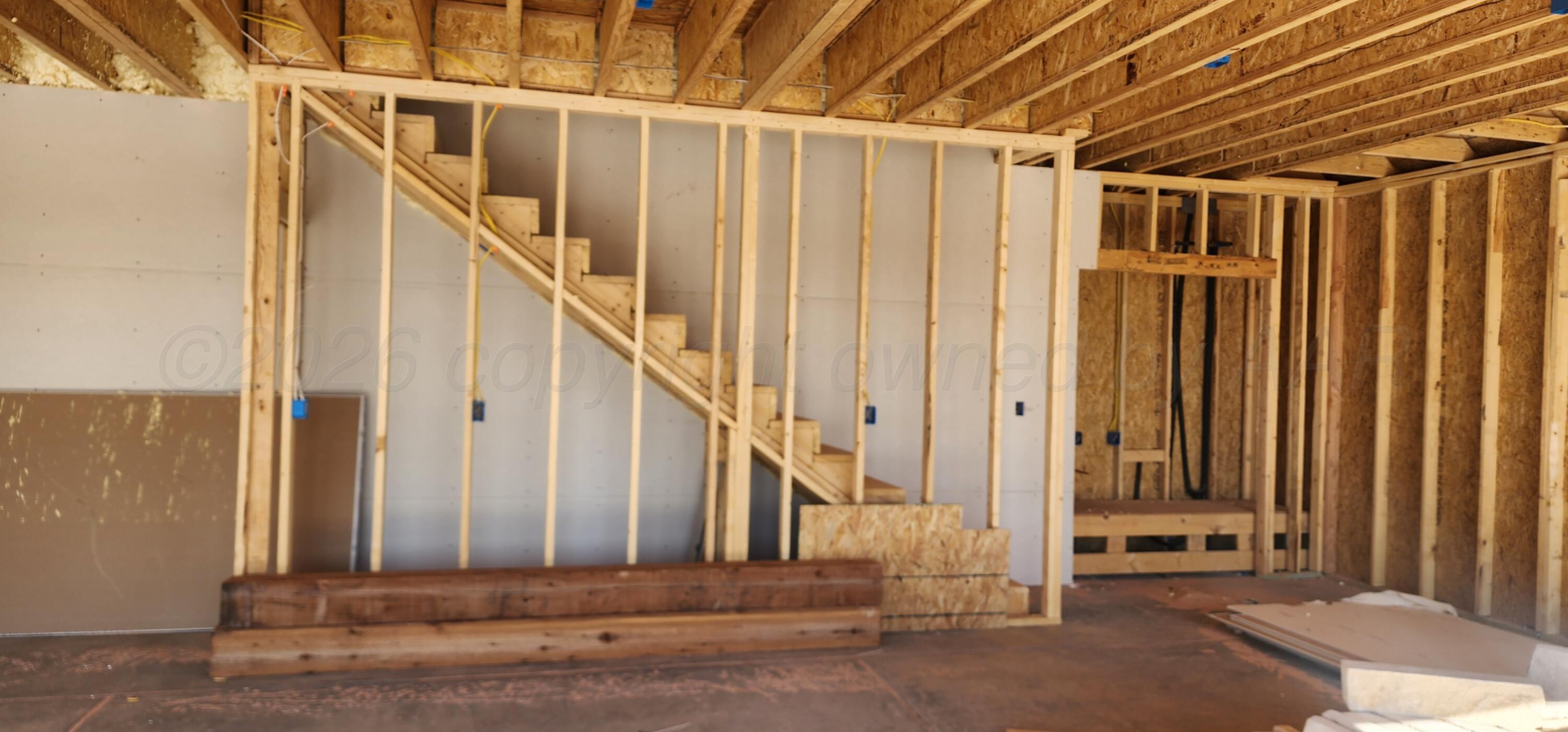 1104 Herring Ranch Road Amarillo, TX 79124 - Photo 5 of 6 a view of a building with wooden floor and stairs