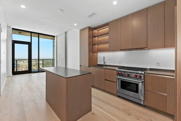 a kitchen with stainless steel appliances granite countertop a stove and a refrigerator